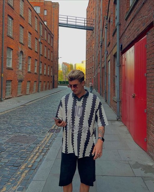 ASOS DESIGN oversized polo with sports graphic and all over print
